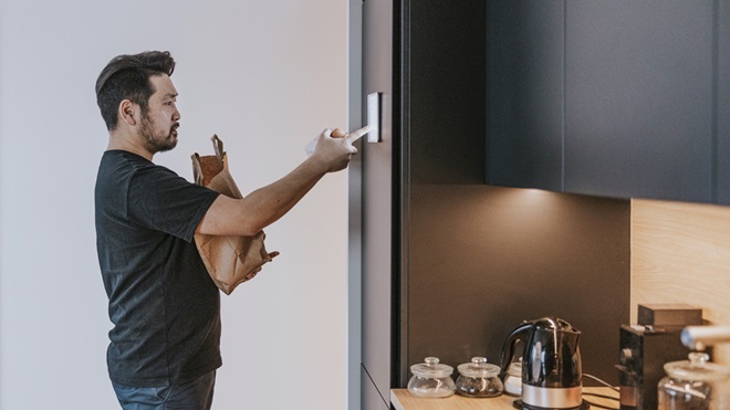 man using a touch screen on a smart fridge